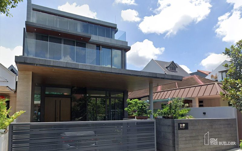 Modern three-story house with glass panels and a sleek facade.