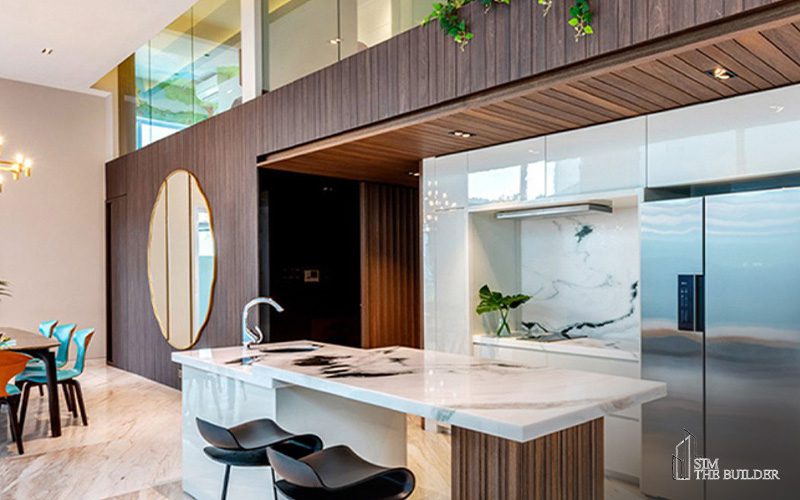 Contemporary landed property design with a marble kitchen island, built-in cabinets, high ceiling and wooden dining area